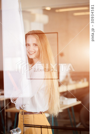 A woman in an office in business clothes: a skirt 30934581