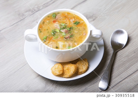 Peas soup with meat, smoked sausage and croutons Peas soup with meat, smoked sausage and croutons 30935518
