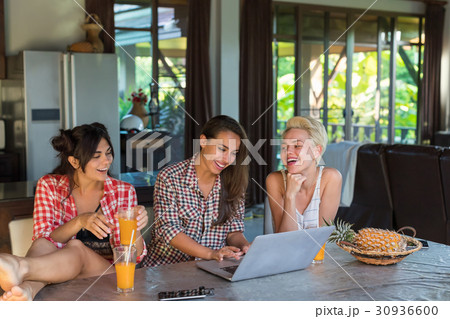Three Girls Sitting At Table Use Laptop Computer 30936600