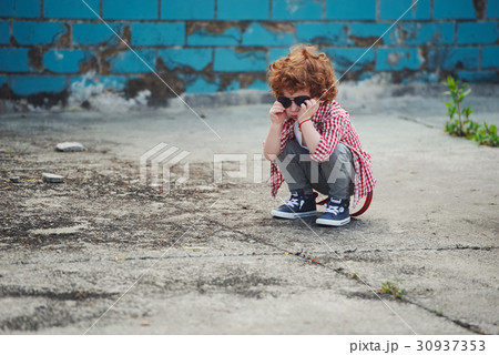 little serious boy with sunglasses little serious boy with sunglasses 30937353