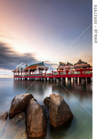 Chinese style pavilion in sea with twilight 30937950