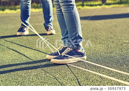 Young girls playing chinese jumping rope 30937973