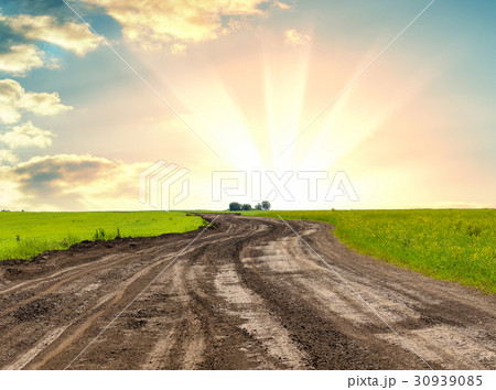 A dirt road against beautiful sunrise 30939085