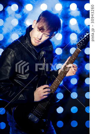 young rock musician playing electric guitar and young rock musician playing electric guitar and 30943260