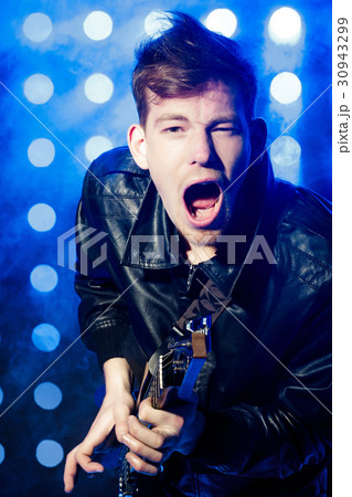 young rock musician playing electric guitar and young rock musician playing electric guitar and 30943299