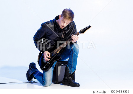young expressive rock musician playing electric young expressive rock musician playing electric 30943305