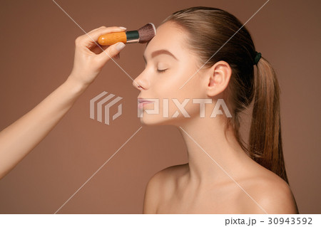 Beautiful female eyes with make-up and brush 30943592