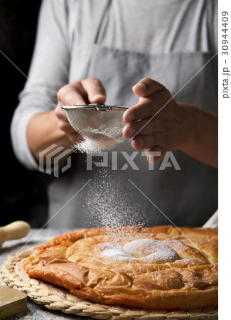 man preparing ensaimada typical of Mallorca, Spain 30944409