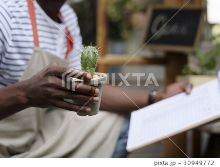 Adult Man Checking Plants Outside Flower Shop Adult Man Checking Plants Outside Flower Shop 30949772