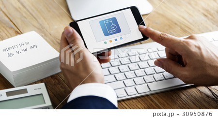 Hands working on digital device network graphic overlay Hands working on digital device network graphic overlay 30950876