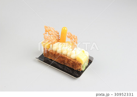 Slice of cream cake with chocolate on  30952331