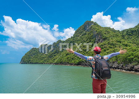 Happy backpacker man standing enjoy with rise arm Happy backpacker man standing enjoy with rise arm 30954996