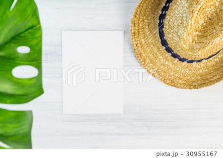 white card on wood table top view with straw hat white card on wood table top view with straw hat 30955167