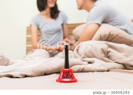 A red bell call for sex with happy couple on bed 30956293