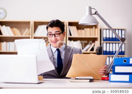 Businessman receiving letter envelope in office Businessman receiving letter envelope in office 30958930