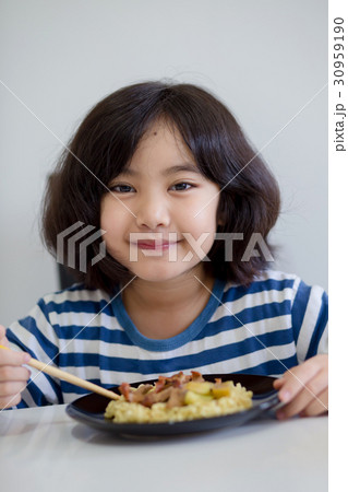 Happy Asian child eating delicious noodle Happy Asian child eating delicious noodle 30959190