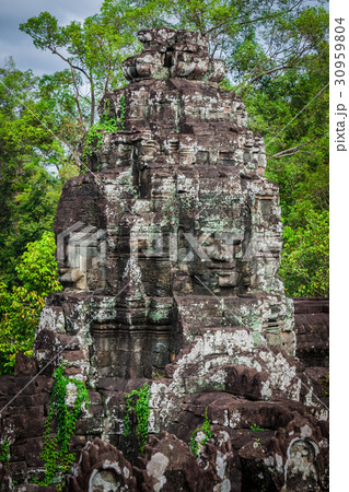 Ancient stone faces of Bayon temple, Angkor Ancient stone faces of Bayon temple, Angkor 30959804
