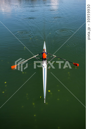Young woman rowing in boat on the lake 30959930