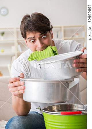 Man at home dealing with neighbor flood leak Man at home dealing with neighbor flood leak 30960696