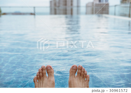 Relaxing in summer, on roof top swimming pool  30961572
