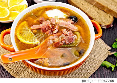 Solyanka with lemon and black olives in bowl Solyanka with lemon and black olives in bowl 30962766