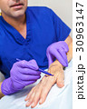 Plastic Surgeon Doctor Marks Hand of Senior Woman 30963147