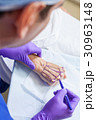 Plastic Surgeon Doctor Marks Hand of Senior Woman 30963148