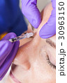 Cosmetic Surgeon Doctor Giving Botox to Woman Face 30963150