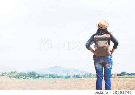 Happy woman traveler looking to blue sky Happy woman traveler looking to blue sky 30963749