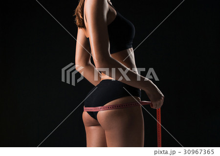 The fit woman measuring perfect shape of beautiful The fit woman measuring perfect shape of beautiful 30967365