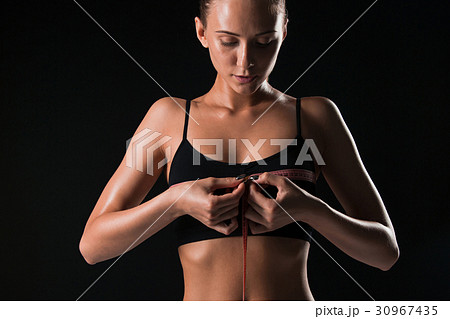 The fit woman measuring perfect shape of beautiful The fit woman measuring perfect shape of beautiful 30967435