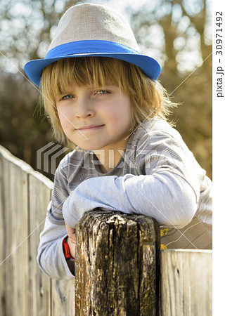 Cute Boy on Fence 30971492