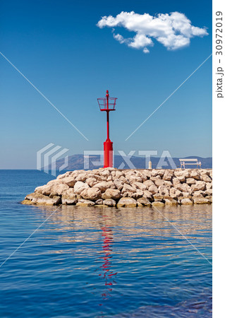 Beautiful seascape with lighthouse. Calm sea and a 30972019