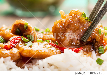 Sirloins on sweet and sour sauce served with rice 30972126