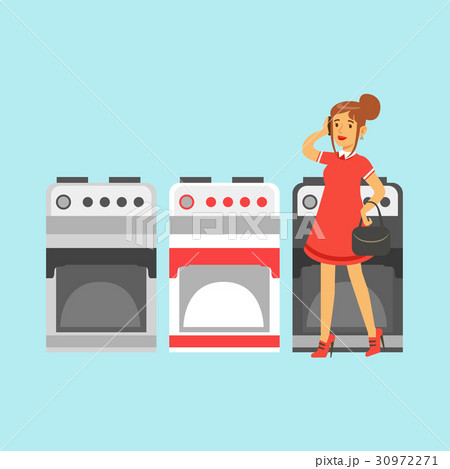 Young woman choosing an electric stove in home Young woman choosing an electric stove in home 30972271