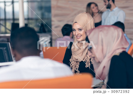 Arabic business woman wearing hijab,working in Arabic business woman wearing hijab,working in 30972392
