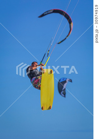 Young atletic man riding kite surf on a sea 30974919