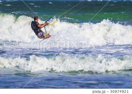 Young atletic man riding kite surf on a sea 30974921