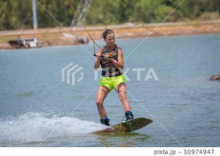 Woman study wakeboarding on a blue lake 30974947