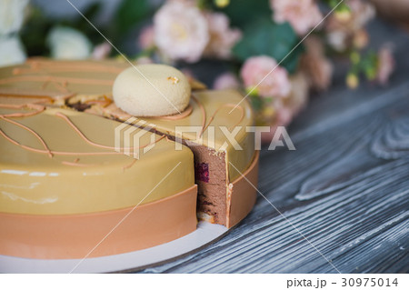 Bakery with piece of unusual yellow mousse cake 30975014