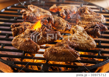 Grilling chicken wings on barbecue grill Grilling chicken wings on barbecue grill 30975712