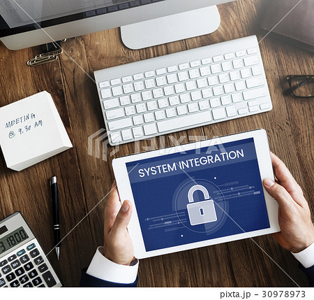 Hands working on digital device network graphic overlay 30978973