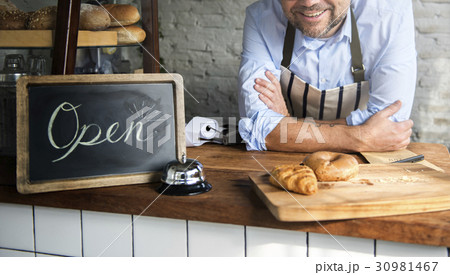 African Man with Open Sign in Bakery Shop African Man with Open Sign in Bakery Shop 30981467