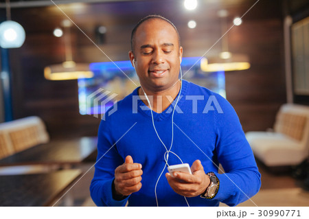 young man with headphones listening to music 30990771