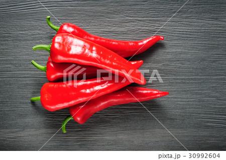 Sweet red Kapia peppers on a dark shale stone Sweet red Kapia peppers on a dark shale stone 30992604