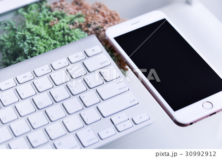 White Keyboard oand smartphone on glass table White Keyboard oand smartphone on glass table 30992912