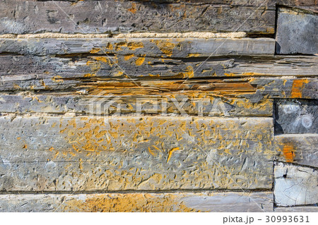 Fragment of the wall of an old wooden house. 30993631