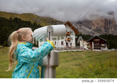 Little girl looks through binoculars Little girl looks through binoculars 30993874