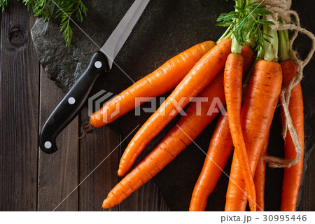 Heap of ripe carrots. 30995446