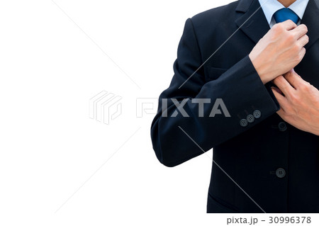 Businessman rearrange his neck tie 30996378